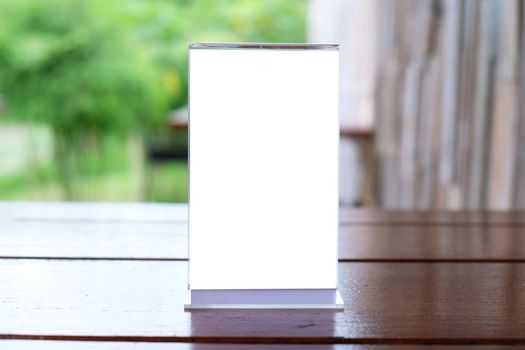 Menu frame standing on wood table in Bar restaurant cafe. space for text marketing promotion