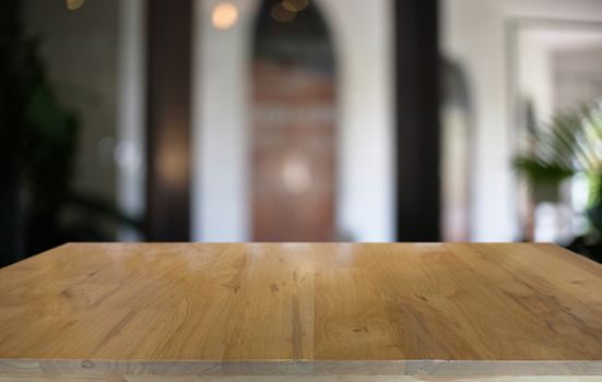 Empty dark wooden table in front of abstract blurred bokeh background of restaurant . can be used for display or montage your products.Mock up for space