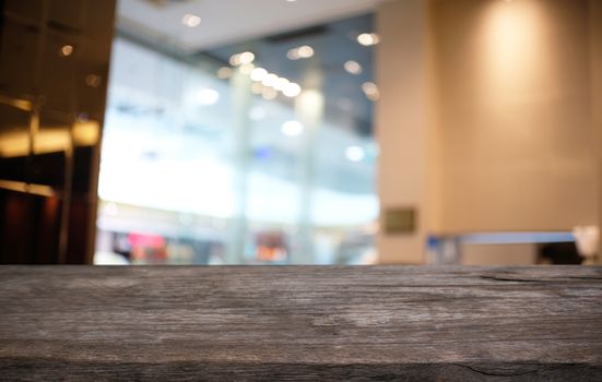 Empty dark wooden table in front of abstract blurred bokeh background of restaurant . can be used for display or montage your products.Mock up for space