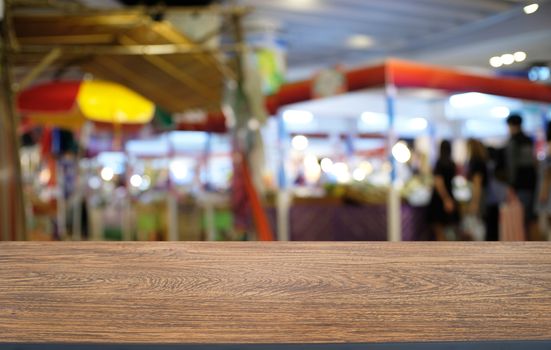 Empty dark wooden table in front of abstract blurred bokeh background of restaurant . can be used for display or montage your products.Mock up for space