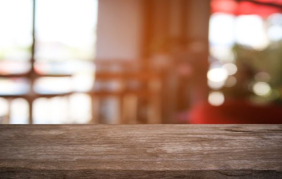 Empty dark wooden table in front of abstract blurred bokeh background of restaurant . can be used for display or montage your products.Mock up for space