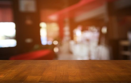 Empty dark wooden table in front of abstract blurred bokeh background of restaurant . can be used for display or montage your products.Mock up for space