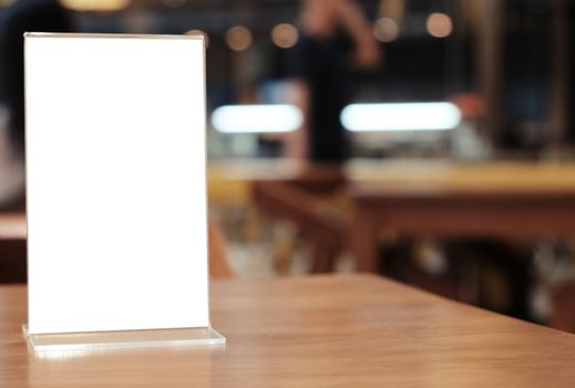 Menu frame standing on wood table in Bar restaurant cafe. space for text marketing promotion