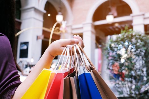 Asian girls holding sale shopping bags. consumerism lifestyle concept in the shopping mall