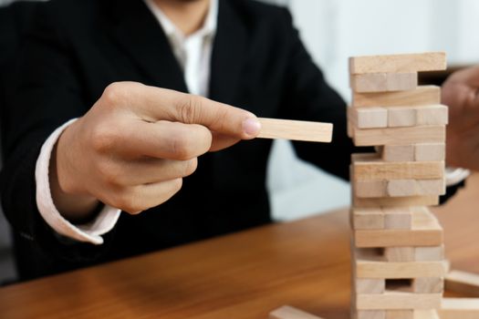 Planning risk and strategy in businessman gambling placing wooden block.Business concept for growth success process.