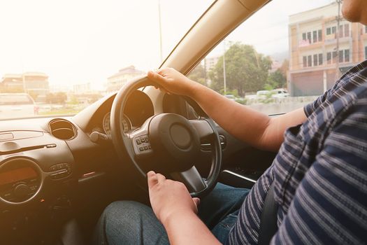 Man driving with both hands on steering wheel selective focus. safety driving concept