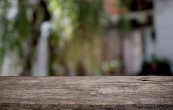 Empty dark wooden table in front of abstract blurred bokeh background of restaurant . can be used for display or montage your products.Mock up for space