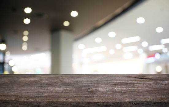 Empty dark wooden table in front of abstract blurred bokeh background of restaurant . can be used for display or montage your products.Mock up for space