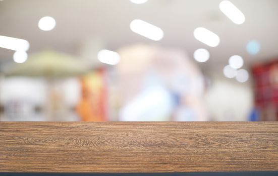 Empty dark wooden table in front of abstract blurred bokeh background of restaurant . can be used for display or montage your products.Mock up for space