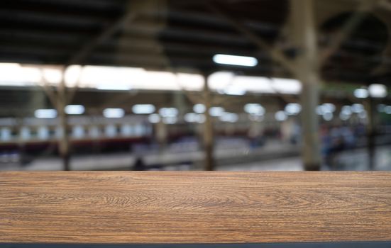 Empty dark wooden table in front of abstract blurred bokeh background of restaurant . can be used for display or montage your products.Mock up for space