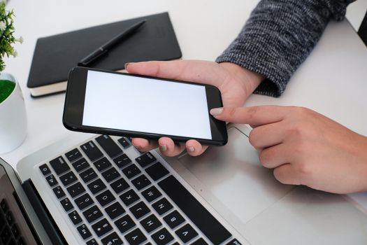 girl using smart phone in office. hand holding smart phone white screen.