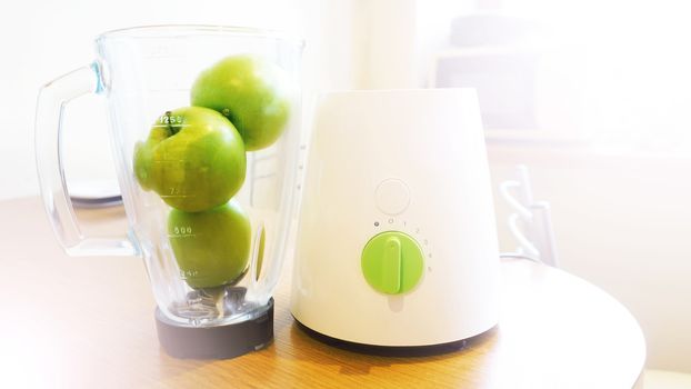 fresh green apples and white kitchen interior and wooden table place