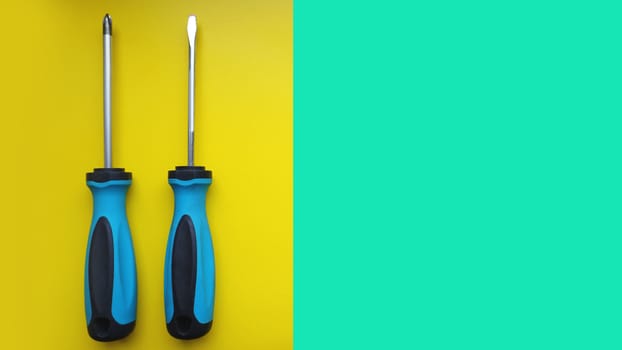 Screwdriver isolated on bright Background. Top View of Blue Handle Screwdriver Tool with Real Shadow. Space for Text or Image