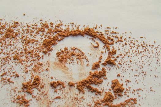 Scattered beige powder, Crumbles natural makeup powder on white background.