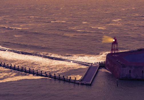 the pier jetty of Vlissingen with lighted lighthouse, Sea landscape at night, Zeeland, The Netherlands