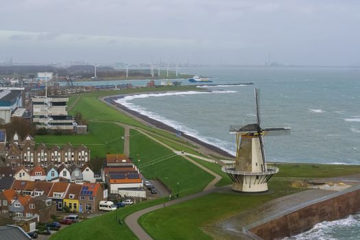 beautiful skyline of the windmill of Vlissingen with some houses and view at sea, typical dutch landscape, popular city in zeeland, The netherlands