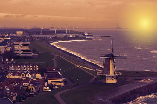 beautiful sunset at the windmill of Vlissingen, city skyline of a popular town in the evening, Zeeland, The Netherlands