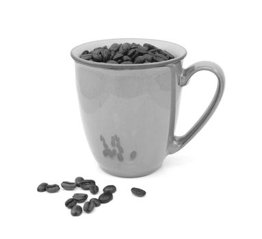 Dark roasted coffee beans in a mug and spilled beside, on a white background - monochrome processing