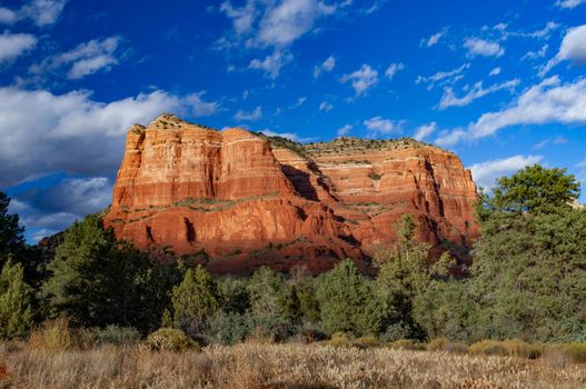 Courthouse Rock in Village of Oak Creek in Arizona with a blue sky with clouds.