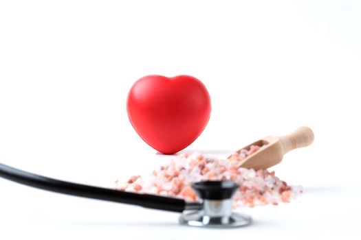 Red Heart Focused With Salt And Black Stethoscope Isolated on White Background