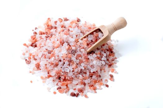 Wood Spoon in a Pile of Himalaya Salt Isolated on White Background