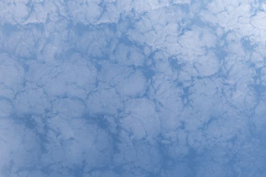 White fluffy clouds on a blue sky background