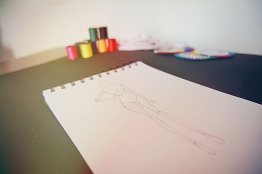 Sketches of Fashion Clothing Design Drawing in atelier. Creative Design Concept.