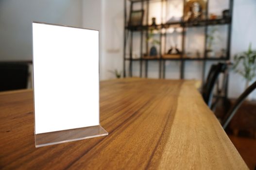 Mock up Menu frame standing on wood table in Bar restaurant cafe. space for text