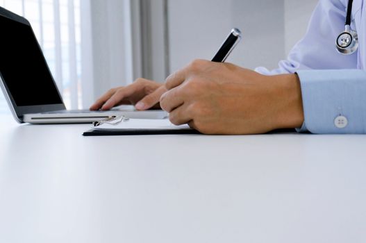 close up of patient and doctor taking notes or Professional medical doctor in white uniform gown coat interview