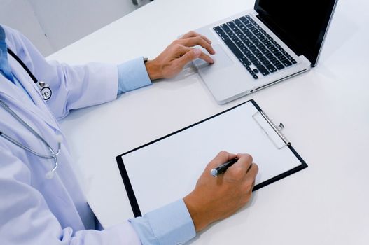 close up of patient and doctor taking notes or Professional medical doctor in white uniform gown coat interview