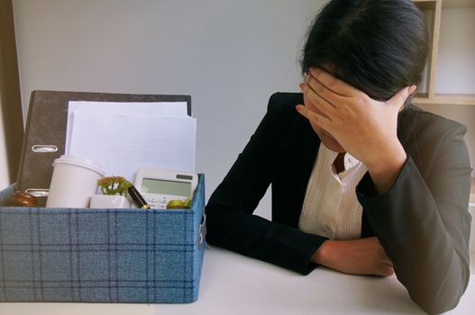 Business woman moving offices packing up Cardboard Box in office