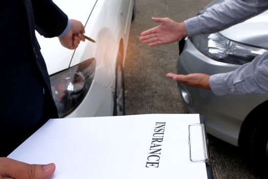 Loss Adjuster Insurance Agent Inspecting Damaged Car 
