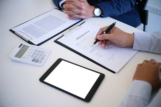 Sales manager giving advice application form document, considering mortgage loan offer for car and house insurance