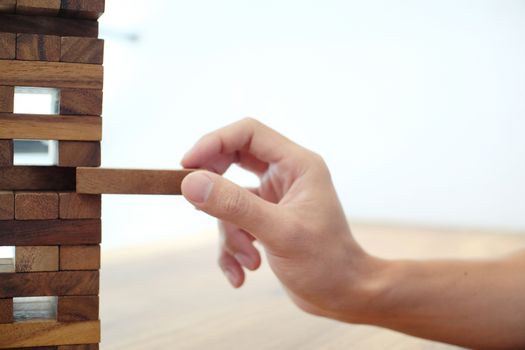 Group of Friends playing blocks wood game on the table folded puzzle