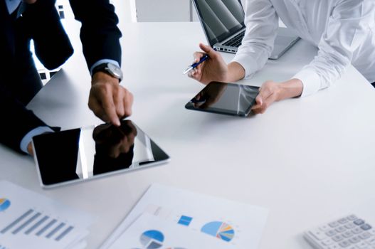 Business people making presentation with his colleagues and business tablet digital computer as meeting concept