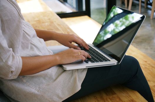 The Casual business woman works online on laptop which hand on keyboard in her house Isolated screen in laptop