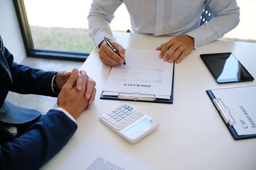 Sales manager giving advice application form document, considering mortgage loan offer for car and house insurance