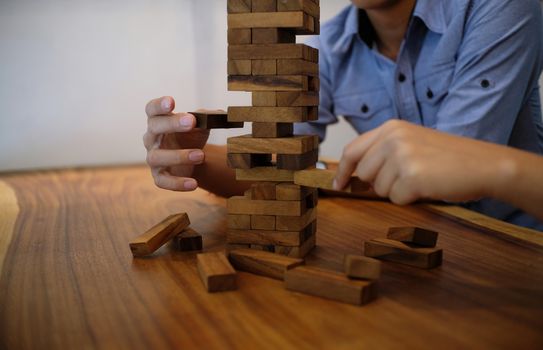 Group of Friends playing blocks wood game on the table folded puzzle