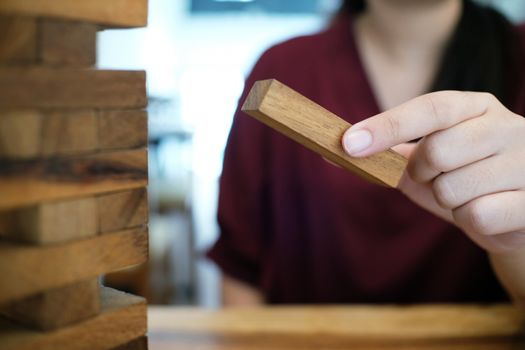 Group of Friends playing blocks wood game on the table folded puzzle