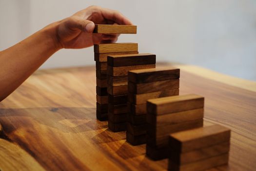 Planning risk and strategy in businessman gambling placing wooden block.Business concept for growth success process.