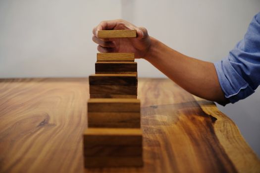 Planning risk and strategy in businessman gambling placing wooden block.Business concept for growth success process.