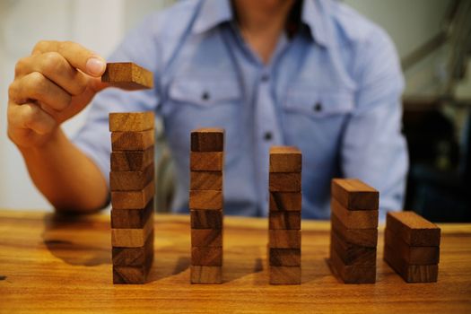 Planning risk and strategy in businessman gambling placing wooden block.Business concept for growth success process.