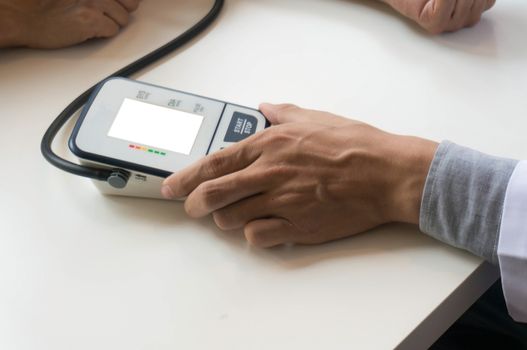 Doctor checking old woman patient arterial blood pressure. Health care