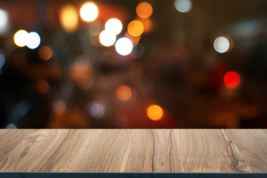 Empty wood table top and blur of night market background/selective focus .For montage product display