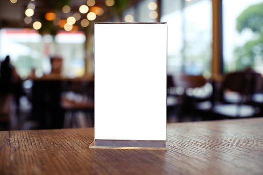 Mock up Menu frame standing on wood table in Bar restaurant cafe. space for text.