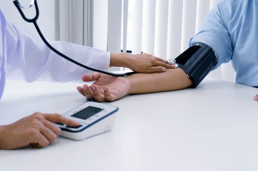 Doctor checking old woman patient arterial blood pressure. Health care.