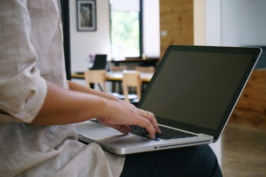 The Casual business woman works online on laptop which hand on keyboard in her house Isolated screen in laptop