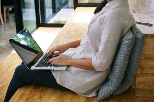 The Casual business woman works online on laptop which hand on keyboard in her house Isolated screen in laptop