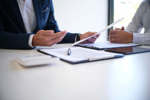 Sales manager giving advice application form document, considering mortgage loan offer for car and house insurance