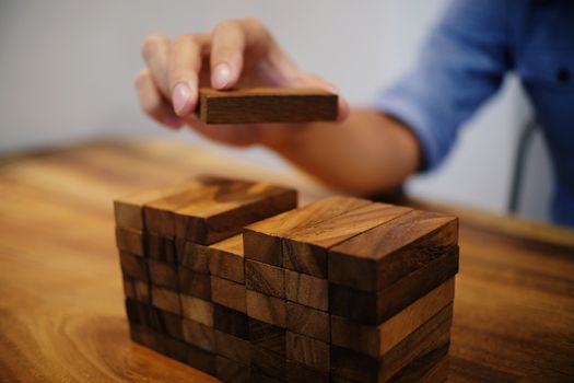 Planning risk and strategy in businessman gambling placing wooden block.Business concept for growth success process.